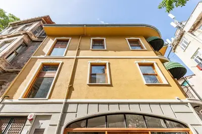 a yellow building with windows on a street at Beautiful Bright Cool Modern 1BD Balat Loft! #329 in Istanbul