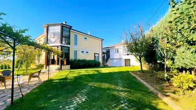 a house with a green lawn in front of it at Bizim Ev in Sapanca