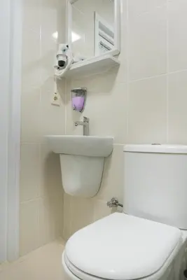 a bathroom with a white toilet and a sink at Koçak Pansiyon in Istanbul