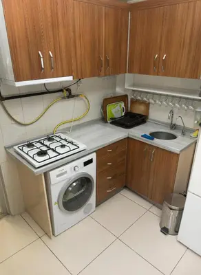 a small kitchen with a washing machine and a sink at Koçak Pansiyon in Istanbul