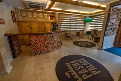 a large room with a bar with a pile of wood at PASHA PALACE HOTEL in Istanbul