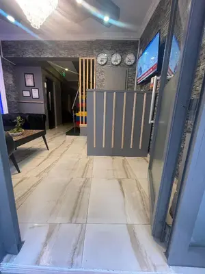 a hallway with wooden floors and a tv and clocks at Ufuk Hotel in Istanbul