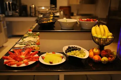 a counter with plates of fruits and vegetables on it at HaciBayramApart in Istanbul