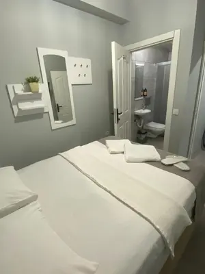 a white bed in a room with a bathroom at Kadıköy Miski Amber in Istanbul
