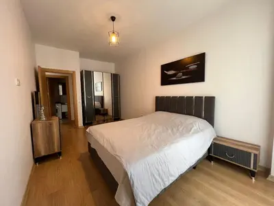 a bedroom with a white bed and a wooden floor at Cozy Home 1 Room 1 Living Room Apartment in Esenyurt
