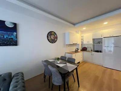 a living room with a dining room table and a kitchen at Cozy Home 1 Room 1 Living Room Apartment in Esenyurt