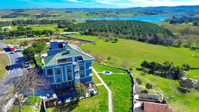 an aerial view of a large blue house on a green field at Green Roof Boutique Hotel & SPA Istanbul Airport in Terkos