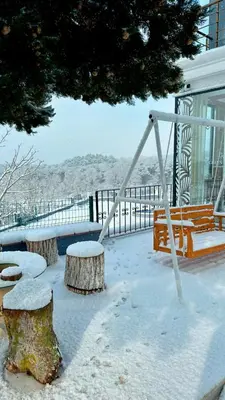 a swing and two logs in the snow at Green Roof Boutique Hotel & SPA Istanbul Airport in Terkos