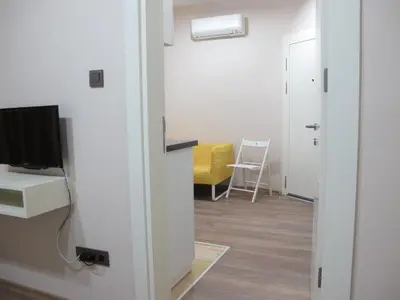 a room with a tv and a desk with a chair at Stay Juno in Istanbul