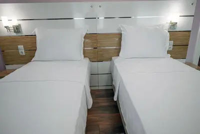 two beds in a hotel room with white pillows at TOK EPİK HOTEL in Bursa