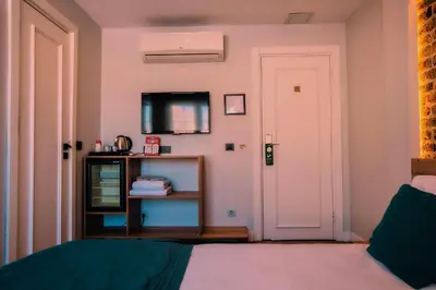a bedroom with a bed and a white door at Taksim Santa Lucia Hotel in Istanbul