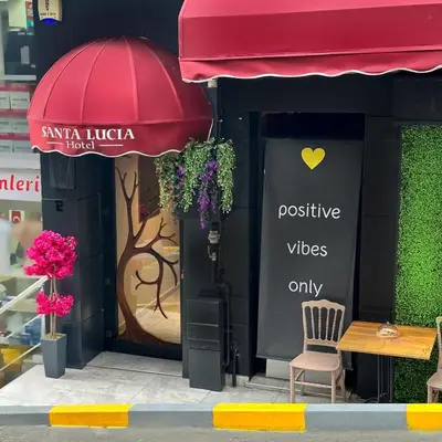 a store front with a red umbrella and a bench at Taksim Santa Lucia Hotel in Istanbul