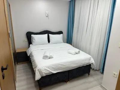 a bedroom with a bed with two towels on it at Koçyiğit Suite & Hotel in Istanbul