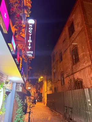 an empty street at night with a neon sign at Koçyiğit Suite & Hotel in Istanbul