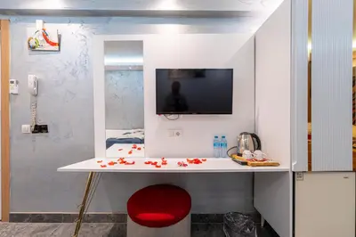a room with a desk with a tv on a wall at Stay Suite Hotel in Istanbul