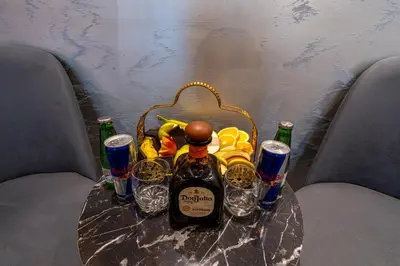a table with a basket of drinks and a bottle of wine at Stay Suite Hotel in Istanbul