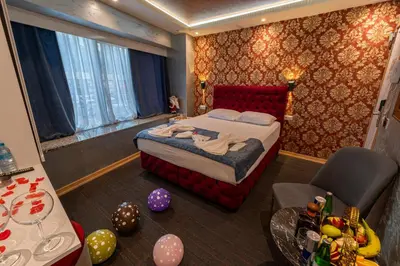 a bedroom with a bed and a room with balloons at Stay Suite Hotel in Istanbul