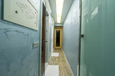 a hallway with blue walls and a hallway with a door at Stay Suite Hotel in Istanbul