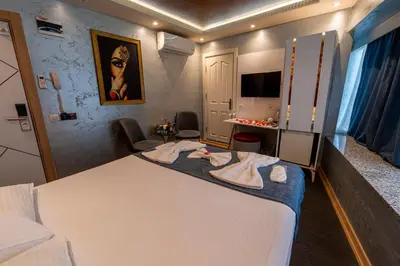 a hotel room with a large bed and a tv at Stay Suite Hotel in Istanbul