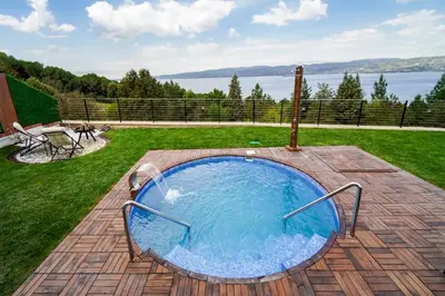 a swimming pool on a patio with a view of the water at Lake Look Sapanca in Sapanca