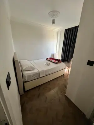 a small room with a bed and a window at Airport Confort Guest House in Arnavutköy