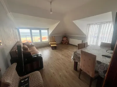 a living room with a couch and a table at Airport Confort Guest House in Arnavutköy