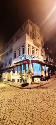 a large white building on the side of a street at SAND DOOR HOTEL in Istanbul