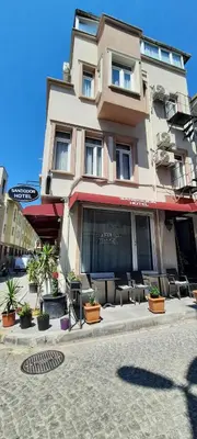 a building with tables and chairs in front of it at SAND DOOR HOTEL in Istanbul