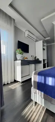 a bedroom with a bed and a tv in a room at SAND DOOR HOTEL in Istanbul