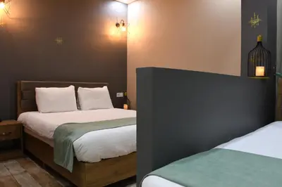 a bedroom with two beds with white sheets at Cibali Hotel Istanbul in Istanbul