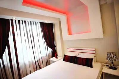 a bedroom with a white bed and a window at Balance Hotel Taksim in Istanbul