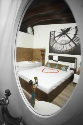 a bedroom with a bed and a clock in a mirror at Balance Hotel Taksim in Istanbul