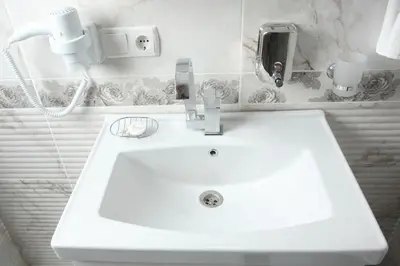 a white sink in a bathroom with a phone at Balance Hotel Taksim in Istanbul