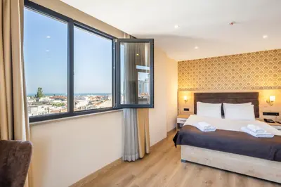 a bedroom with a large bed and large windows at Emin Palace in Istanbul