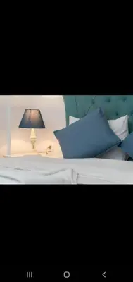 a bed with blue pillows and a lamp on it at 3 FLOOR OLD CITY 1 in Istanbul