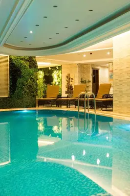 a swimming pool with blue water in a house at Felicity Hotel İstanbul in Istanbul