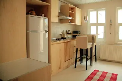 a kitchen with a white refrigerator and a table at Newly renovated apartment-studio in Istanbul