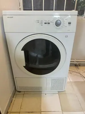 a white washing machine sitting on a tiled floor at Taksim Cihangir'de 2+1 daire in Istanbul