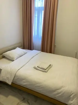 a bed with a white towel on top of it at YENİKAPI hotel in Istanbul