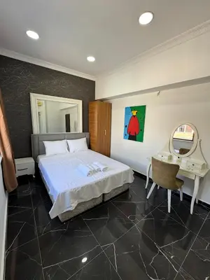 a bedroom with a bed and a desk and a mirror at beyzade apart hotel in Istanbul