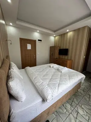 a large white bed in a room with a television at beyzade apart hotel in Istanbul
