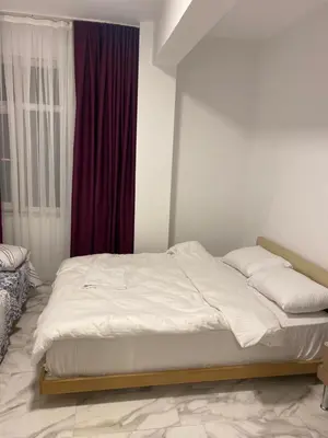 a white bed in a room with a window at YeniKAPI in Istanbul