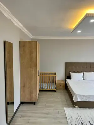 a bedroom with a bed and a wooden door at Ozn Suit Airport Hotel in Arnavutköy