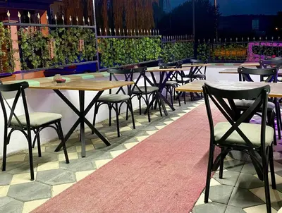 a row of tables and chairs on a patio at Ozn Suit Airport Hotel in Arnavutköy
