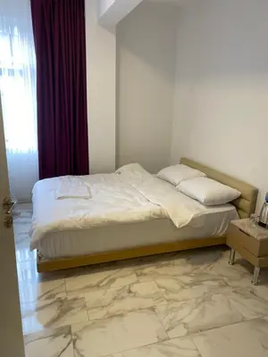 a bed in a bedroom with a marble floor at yenikapı HOTEL in Istanbul