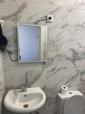 a bathroom with a sink and a mirror and a toilet at yenikapı HOTEL in Istanbul