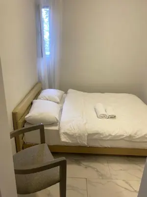 a small bedroom with a bed and a chair at hotel yenikapı in Istanbul