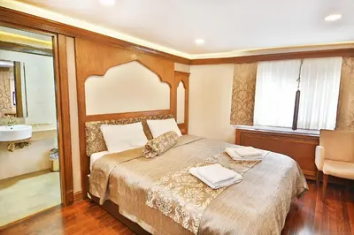 a bedroom with a bed with a sink and a mirror at Kumluk Konak Hotel in Istanbul
