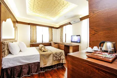 a hotel room with a bed and a desk at Kumluk Konak Hotel in Istanbul
