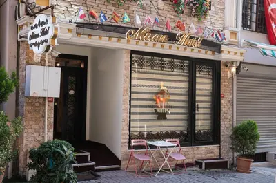 a restaurant with pink chairs and a table in front of it at Istanbul Old City Sultanahmed Miran Hotel in Istanbul